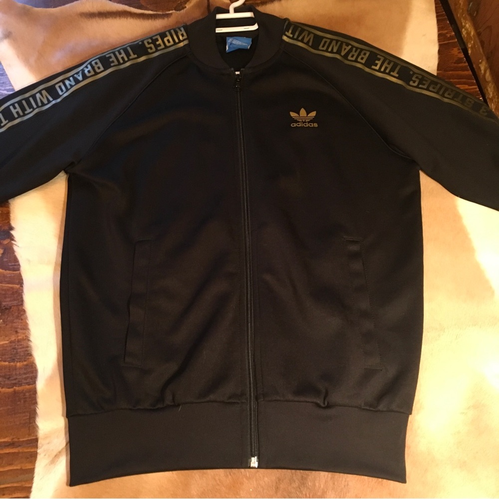 Adidas black gold lettering on arms